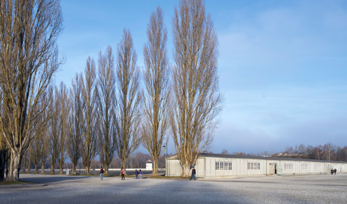 Standing with one’s back to the former maintenance building, on the right-hand side of the poplar-lined road is a reconstructed barrack, marking the onetime location of the sickbay.