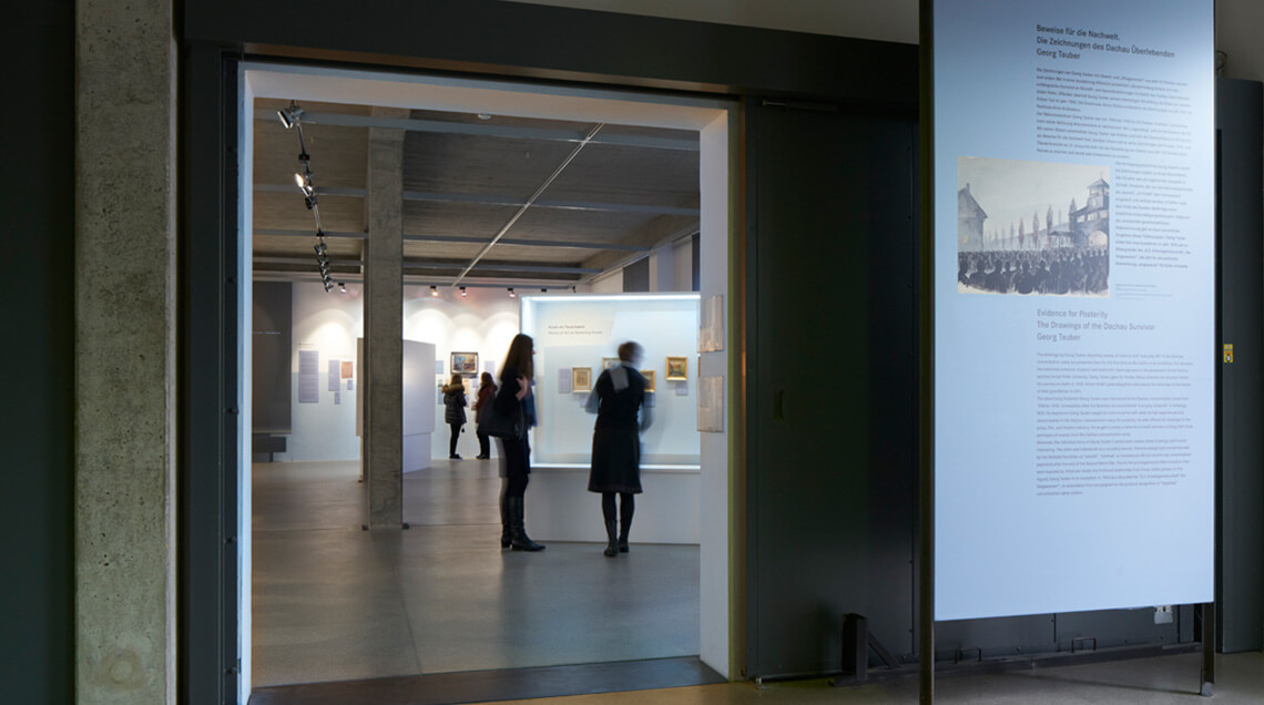 Blick vom Eingang aus in die Ausstellung, die sich Besucherinnen und Besucher ansehen