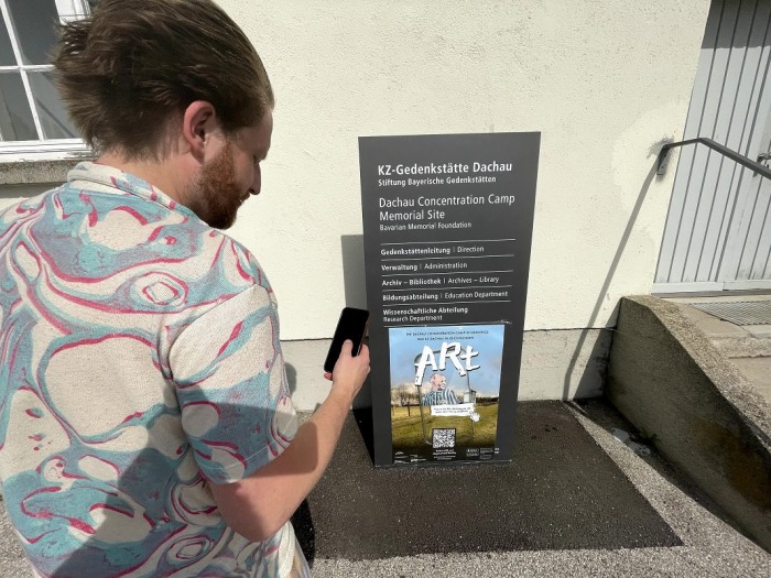 Someone scanning the QR Code of ARt at the memorial site